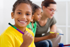 Young boy holding a paint brush